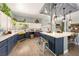 Charming kitchen featuring blue and white cabinets, an island with seating, and natural light at 3360 National Ave, Pahrump, NV 89048