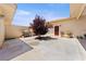 Back patio featuring stucco walls, a barbeque grill, and desert landscaping at 3360 National Ave, Pahrump, NV 89048