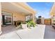 Covered back patio with a ceiling fan, outdoor dining table and desert landscaping at 3360 National Ave, Pahrump, NV 89048