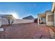Spacious backyard with desert landscaping, a covered patio, and plenty of room for outdoor activities at 4005 Poppy Fields Dr, Las Vegas, NV 89129