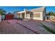 Expansive backyard with a covered patio, desert landscaping, and a charming gazebo for relaxing at 4005 Poppy Fields Dr, Las Vegas, NV 89129
