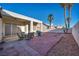 Backyard patio area perfect for entertaining, featuring a brick paver patio, seating, and desert landscaping at 4005 Poppy Fields Dr, Las Vegas, NV 89129