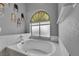 Bright bathroom featuring a large tub under a window with tiled surround at 4005 Poppy Fields Dr, Las Vegas, NV 89129