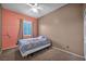 Cozy bedroom features a ceiling fan, window, and comfortable bed at 4005 Poppy Fields Dr, Las Vegas, NV 89129