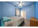 Blue bedroom with modern ceiling fan and natural light window at 4005 Poppy Fields Dr, Las Vegas, NV 89129