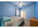 Comfortable bedroom with blue walls, carpet flooring, and a large window for natural light at 4005 Poppy Fields Dr, Las Vegas, NV 89129