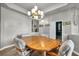 Features an elegant dining area with wood floors and a decorative chandelier at 4005 Poppy Fields Dr, Las Vegas, NV 89129