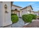 Close up of a charming single-story home entrance, desert landscaping, and inviting entry way at 4005 Poppy Fields Dr, Las Vegas, NV 89129