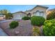 Well-maintained front yard with desert landscaping, mature trees, and a charming single-story home at 4005 Poppy Fields Dr, Las Vegas, NV 89129