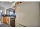 Galley kitchen featuring oak cabinets, granite counters, stainless dishwasher and a bright view at 4005 Poppy Fields Dr, Las Vegas, NV 89129
