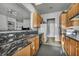 Well-lit kitchen boasting granite countertops, oak cabinets, and modern appliances at 4005 Poppy Fields Dr, Las Vegas, NV 89129