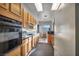 Bright kitchen with oak cabinets, granite countertops, oven and an adjacent breakfast nook at 4005 Poppy Fields Dr, Las Vegas, NV 89129