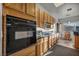 Well-equipped kitchen with wood cabinets, black appliances, and a cozy breakfast nook with great natural light at 4005 Poppy Fields Dr, Las Vegas, NV 89129