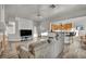 Open floor plan showcasing living room with fireplace, kitchen bar, and dining nook with seamless flow at 4005 Poppy Fields Dr, Las Vegas, NV 89129