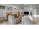 Spacious living room featuring a fireplace, built-in shelving, modern lighting, and wood-look tile flooring at 4005 Poppy Fields Dr, Las Vegas, NV 89129