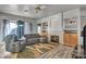 Inviting living room featuring a fireplace, built-in shelving, wood-look flooring, and large windows at 4005 Poppy Fields Dr, Las Vegas, NV 89129