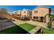 Exterior backyard view showcasing a covered patio and tiered hardscape with artificial grass at 401 Sonoma Valley St, Las Vegas, NV 89144