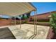Backyard with covered patio, tiered hardscape, and lush flowering plants at 401 Sonoma Valley St, Las Vegas, NV 89144