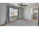 Bright bedroom with a ceiling fan, a large window, and easy access to the laundry room at 401 Sonoma Valley St, Las Vegas, NV 89144