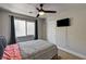 Comfortable bedroom featuring a ceiling fan, a window with curtains, and a mounted TV at 401 Sonoma Valley St, Las Vegas, NV 89144