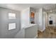 Upstairs hallway featuring wood-look flooring, two small windows, and a laundry closet with a washer and dryer at 401 Sonoma Valley St, Las Vegas, NV 89144