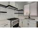 Contemporary kitchen with stainless steel oven and black shelves against a marble-style backsplash at 401 Sonoma Valley St, Las Vegas, NV 89144
