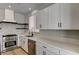 Stylish kitchen with white cabinets, stainless steel appliances, and a modern range hood at 401 Sonoma Valley St, Las Vegas, NV 89144
