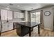 Bright kitchen featuring white cabinetry, an island with a dark stone countertop, and stainless steel appliances at 401 Sonoma Valley St, Las Vegas, NV 89144