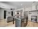 Open concept living area with a large kitchen island, stainless appliances, and a comfortable seating area at 401 Sonoma Valley St, Las Vegas, NV 89144