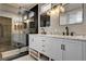 Elegant bathroom featuring a glass-enclosed shower and double vanity with marble top and sleek black faucets at 401 Sonoma Valley St, Las Vegas, NV 89144