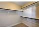 Spacious walk-in closet with carpet and wall-mounted shelves with black bars for easy storage at 401 Sonoma Valley St, Las Vegas, NV 89144