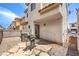 An enclosed backyard features stone pavers, a patio, BBQ, and convenient access to the home at 4037 Asante Cove St, Las Vegas, NV 89115