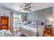 Well-lit bedroom with a ceiling fan and a window overlooking the neighborhood at 4037 Asante Cove St, Las Vegas, NV 89115