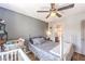 Inviting bedroom featuring wood floors, neutral walls, and ceiling fan at 4037 Asante Cove St, Las Vegas, NV 89115