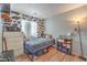 Comfortable bedroom design with black bed, and wood floors at 4037 Asante Cove St, Las Vegas, NV 89115