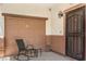 Cozy covered patio with comfortable seating near the garage and front door, offering a welcoming outdoor space at 4037 Asante Cove St, Las Vegas, NV 89115