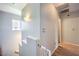 Light and bright hallway leading to a door and featuring wood flooring at 4037 Asante Cove St, Las Vegas, NV 89115