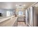 Modern kitchen features stainless steel appliances, sleek countertops, and ample cabinet space, adjacent to the living area at 4037 Asante Cove St, Las Vegas, NV 89115