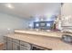 Open-concept kitchen with a breakfast bar, stylish cabinets, and modern appliances, perfect for casual dining and entertaining guests at 4037 Asante Cove St, Las Vegas, NV 89115