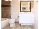 Cozy bathroom featuring a tiled shower, toilet, and single sink vanity with warm neutral tones at 4354 Thorndale Pl, Las Vegas, NV 89103