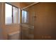 A bathroom with modern shower featuring glass doors and tiled walls at 4354 Thorndale Pl, Las Vegas, NV 89103