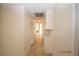 Hallway featuring tiled flooring and ample storage cabinets with access to other rooms of the home at 4354 Thorndale Pl, Las Vegas, NV 89103