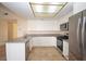 Bright kitchen with stainless steel appliances, granite countertops, and a light tile floor at 4354 Thorndale Pl, Las Vegas, NV 89103