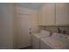 Laundry room with washer, dryer and overhead cabinets offer lots of storage and convenience at 4354 Thorndale Pl, Las Vegas, NV 89103