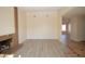 Bright living room with a cozy fireplace, wood-look flooring and neutral walls at 4354 Thorndale Pl, Las Vegas, NV 89103