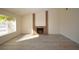 Sun-filled living room features a brick fireplace, wood-look floors, and large window at 4354 Thorndale Pl, Las Vegas, NV 89103