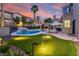 Beautiful backyard with a pool, putting green, and mature landscaping at 464 Beardsley Cir, Henderson, NV 89052