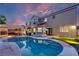 Stunning backyard with a pool, putting green, and outdoor entertainment area at 464 Beardsley Cir, Henderson, NV 89052