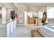 Luxurious bathroom with a spacious walk-in closet, vanity, and soaking tub, creating a spa-like retreat at 464 Beardsley Cir, Henderson, NV 89052