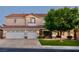 Charming two-story home with a well-maintained lawn, mature trees, and a three-car garage at 464 Beardsley Cir, Henderson, NV 89052